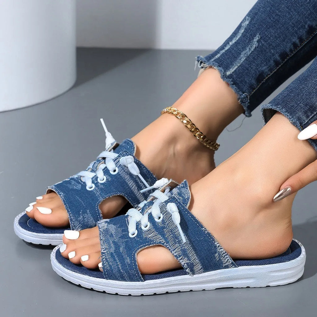 Blue women's Roman-style flat canvas slippers with a cloth upper and rubber sole.