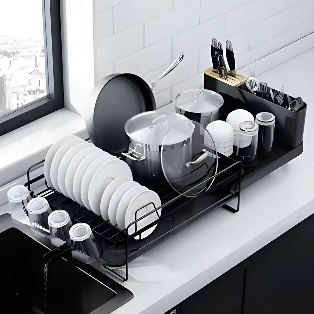 Retractable carbon steel kitchen dish drain rack holding cutlery and cups in a modern simple style.