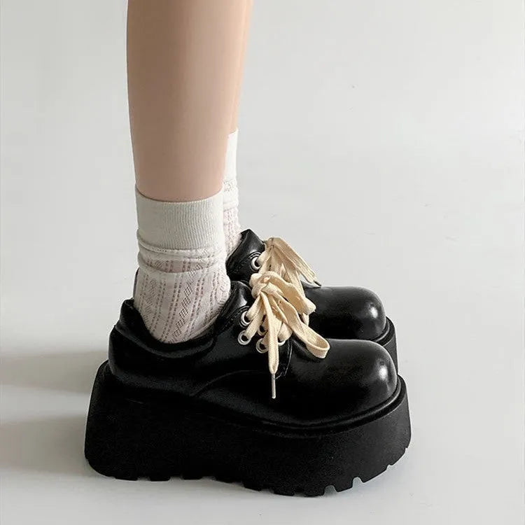 Matte black women's lace-up high-heel shoes with a thick sole and an English muffin heel.