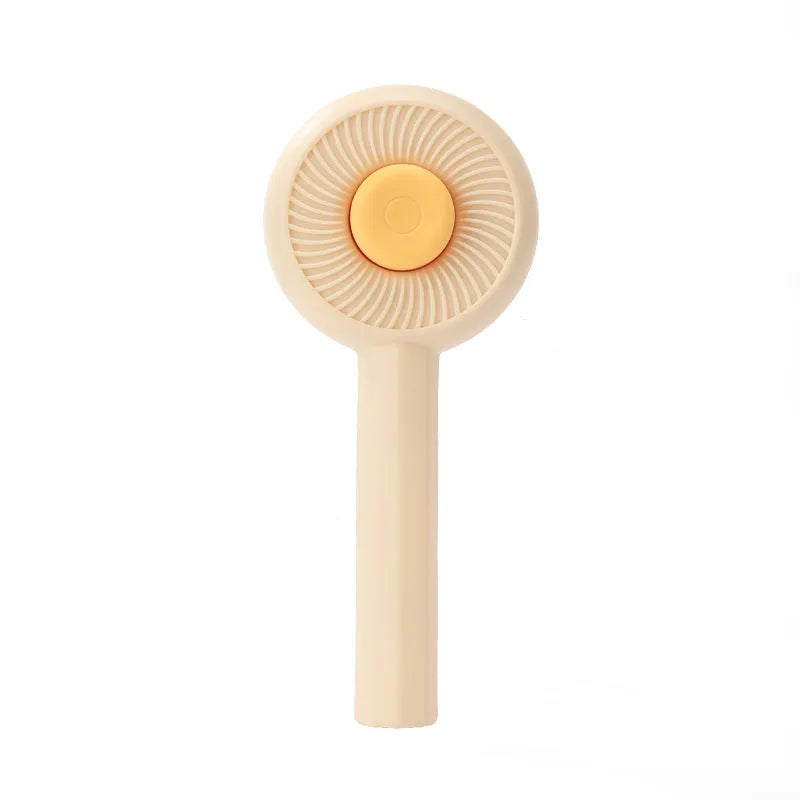 Blue and yellow pet grooming brush with angled metal needles and a self-cleaning button on the handle.
