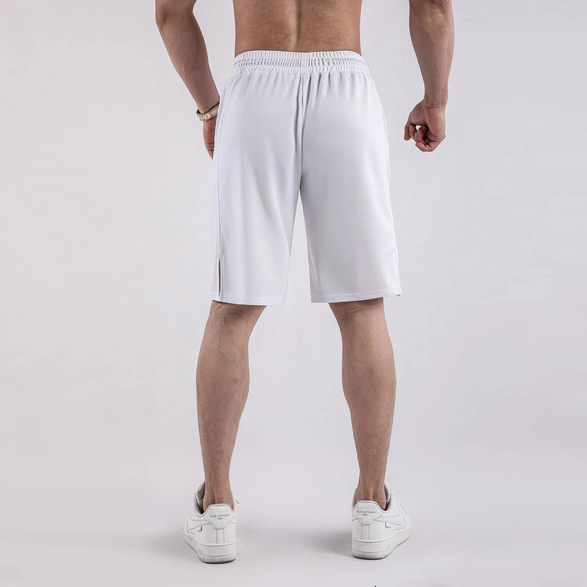 Men's black quick-dry mesh sports shorts with an elastic waistband on a white background.