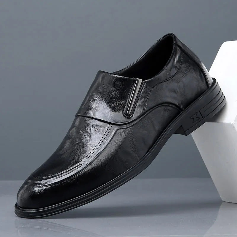 Men's black cowhide leather slip-on casual shoes with rubber sole on a plain background