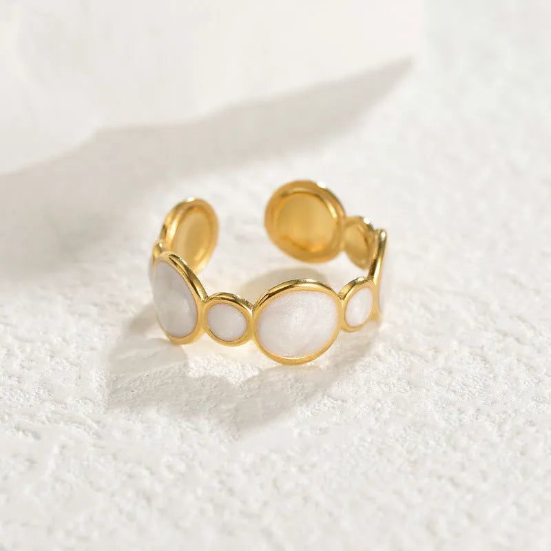 A geometric stainless steel ring for women with an adjustable opening and electroplated finish.