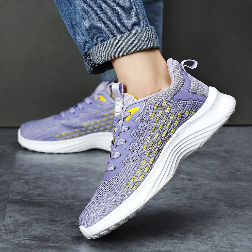 Women's lavender purple flyknit running shoes with mesh upper and striped pattern on a white background.
