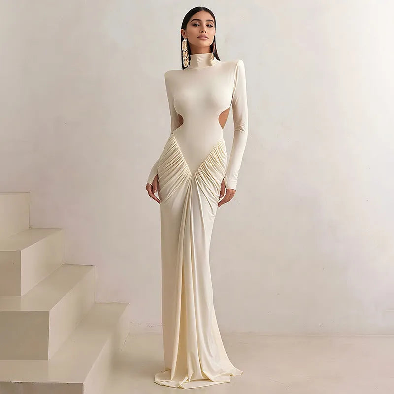 Women's slim fit long sleeve dress with high collar and pleated backless detail in apricot colour.
