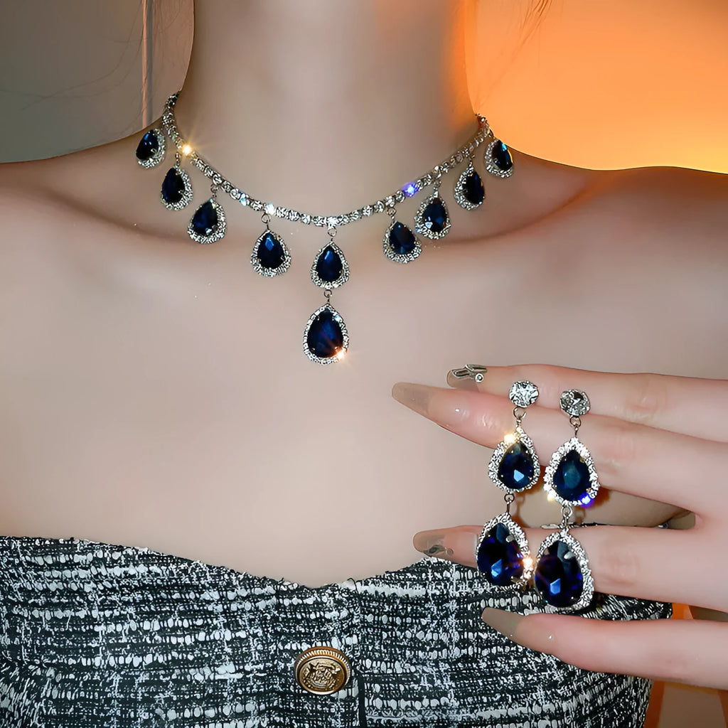 Silver needle water drop earrings and necklace set with blue zircon pendant on display