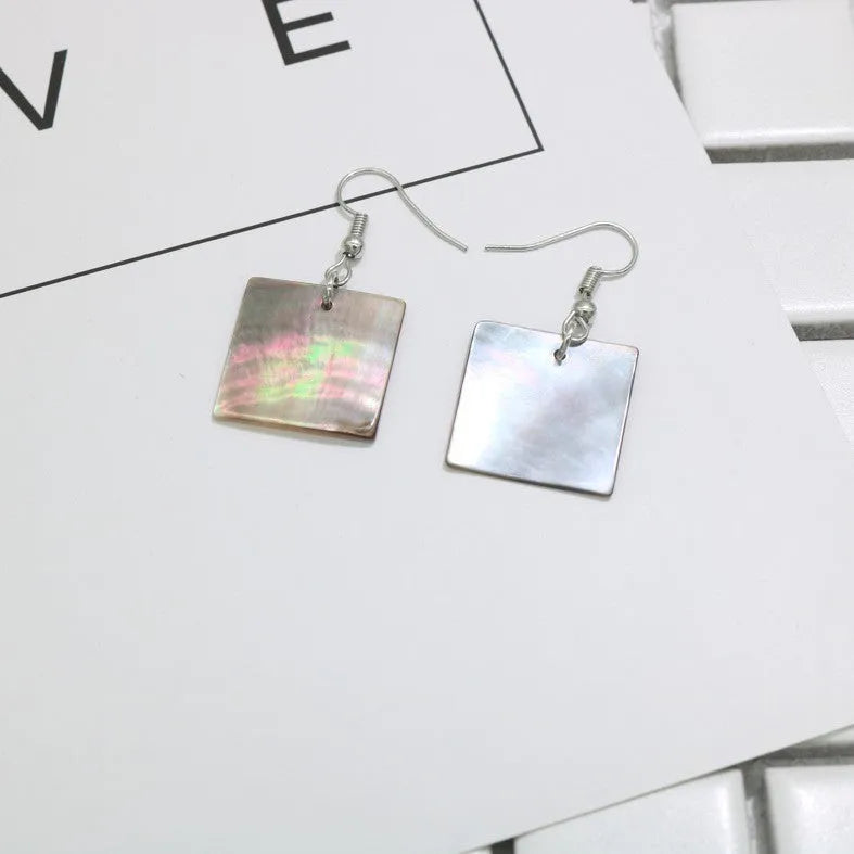 Women's geometric shell earrings showing rectangular and square shapes with natural shell material texture
