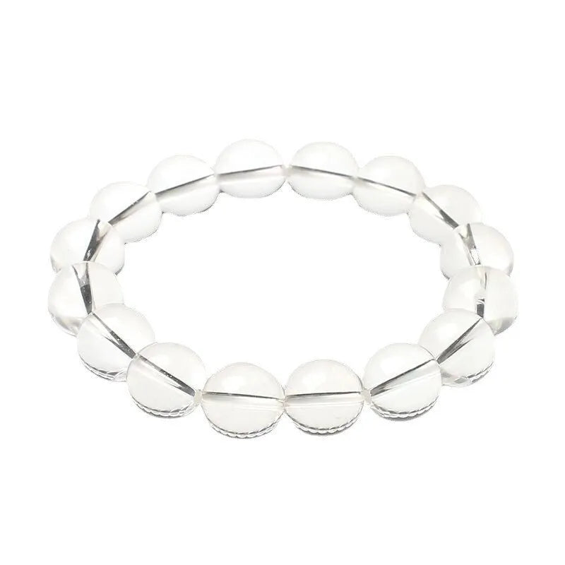 Natural old mine white crystal bracelet with round geometric beads on a wrist.