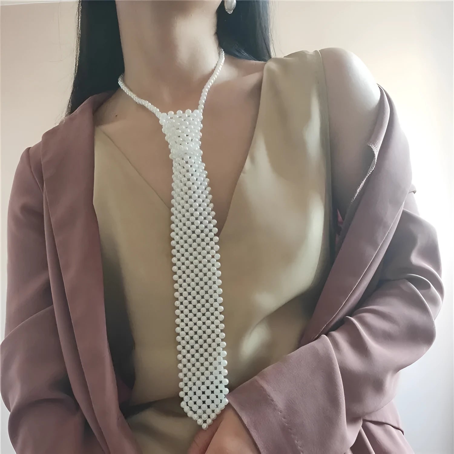 Women's pearl tie body chain with hollow-out design in white or black colour.