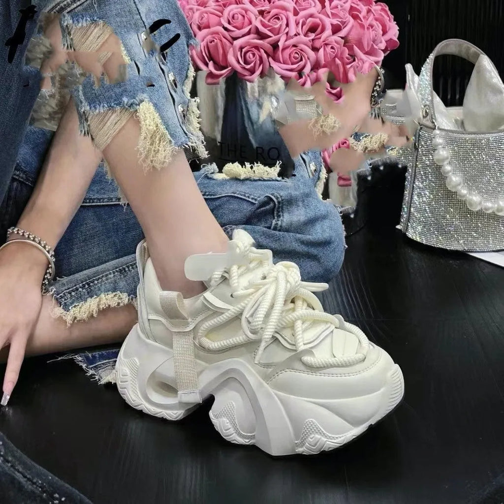 Women's casual wedge sneaker in synthetic leather with a mesh lining and EVA sole.