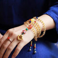 Yellow natural Brazilian citrine bracelet with 1mm beads and filament fastening on a wrist.