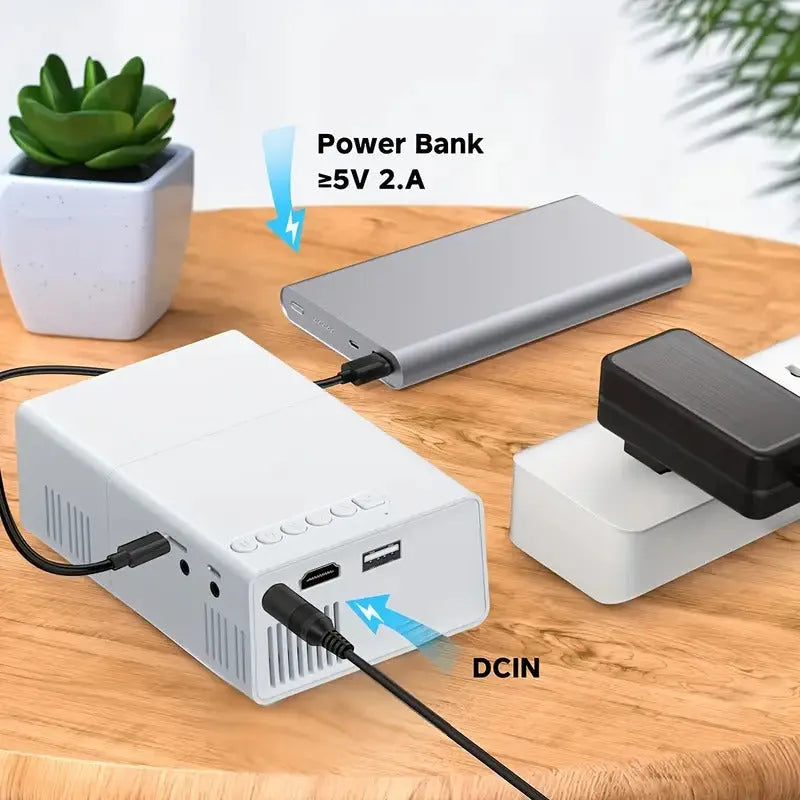 M100 mini home LED projector in black colour showing remote control and power cables