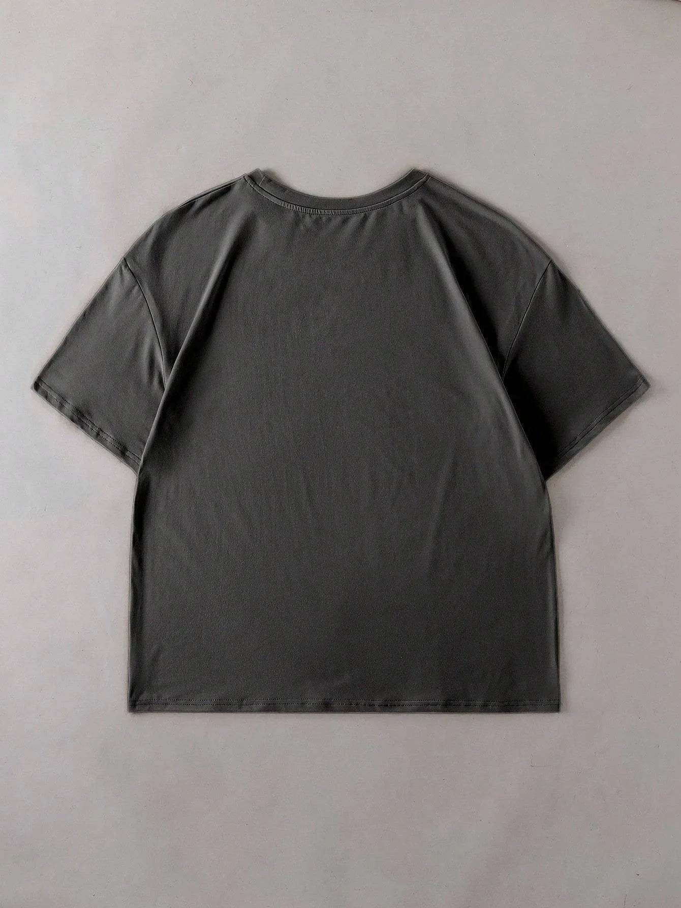 Unisex loose-fit cotton T-shirt in black, shown front-on, with short sleeves and a round neck.