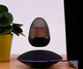 Newest levitating floating speaker in black with magnetic suspension on base showing wireless bluetooth connectivity for home decor