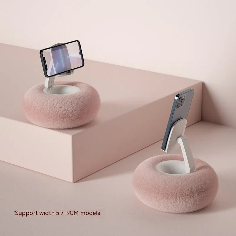 Adjustable rotating phone and tablet bracket on a desk, showing the clamp and fabric base.