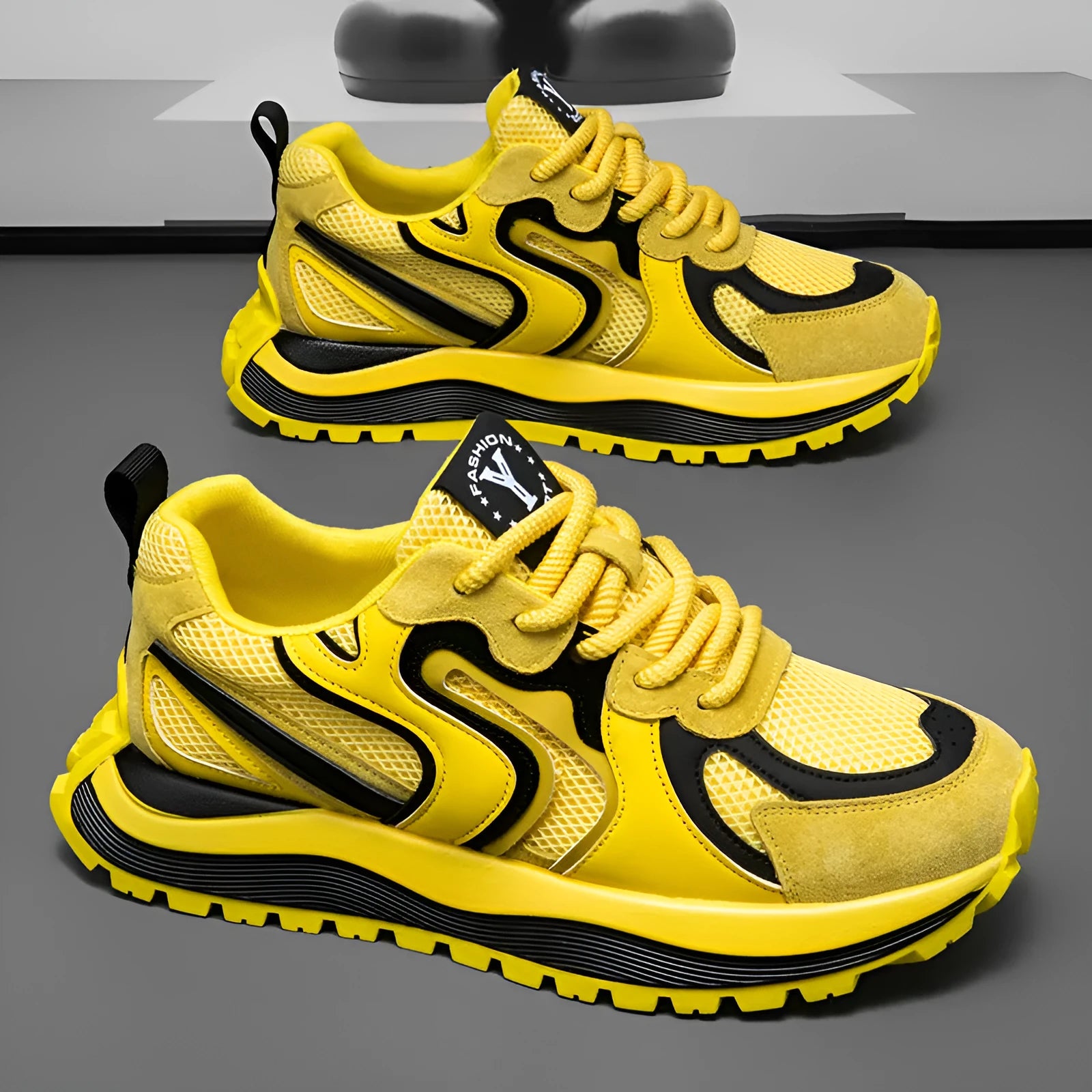 Men's yellow, black, and white mesh and synthetic leather casual sneakers with round toe and lace-up front.