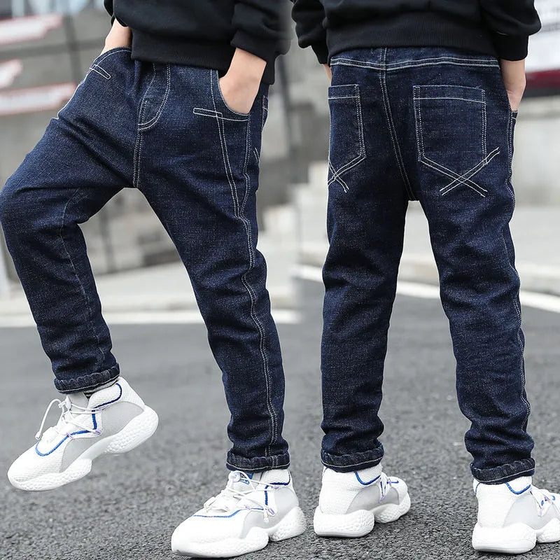 Boys velvet-lined jeans in blue with cartoon-man print, available in sizes 110cm to 160cm