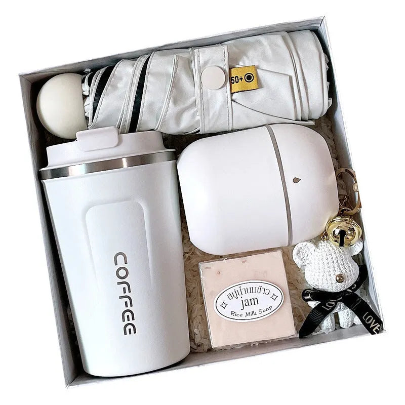 Metal business gift set with bracket, keychain, umbrella, cup, and data cable on a neutral background