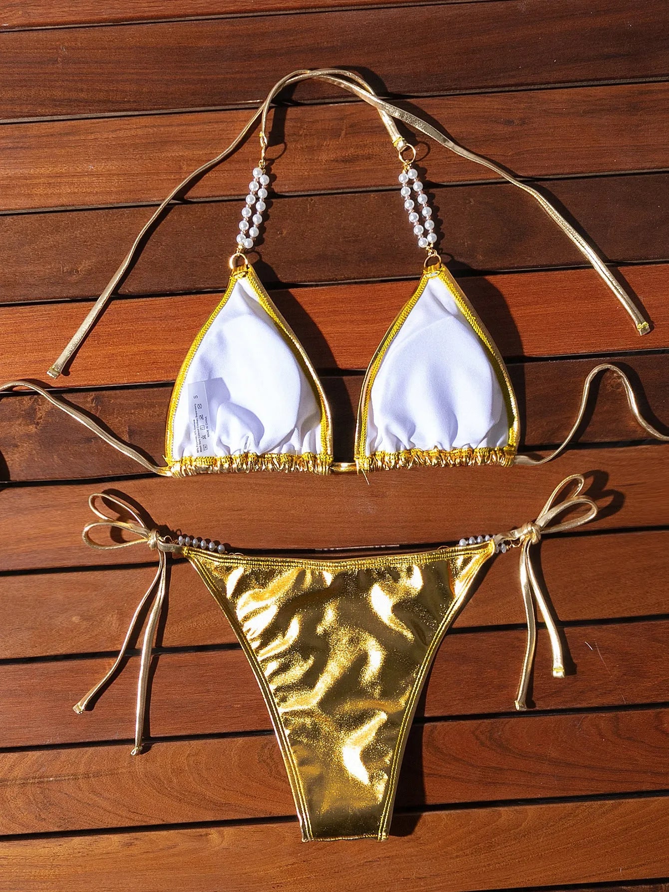 Gold halter lace-up bikini with pearl chain detail and briefs-style bottoms