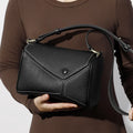Women's genuine leather crossbody bag in soft first layer cowhide, square shape, 22x11x15cm, black colour option on a plain background