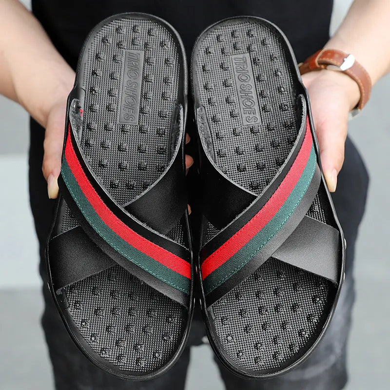 Men's white cowhide leather flip-flops with a PU sole on a sandy beach