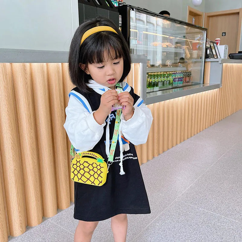 Silicone children's coin purse in round yellow with cartoon donut pattern and crossbody strap