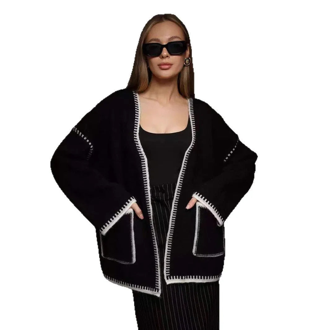Loose mid-length knitted cardigan in camel colour on a hanger