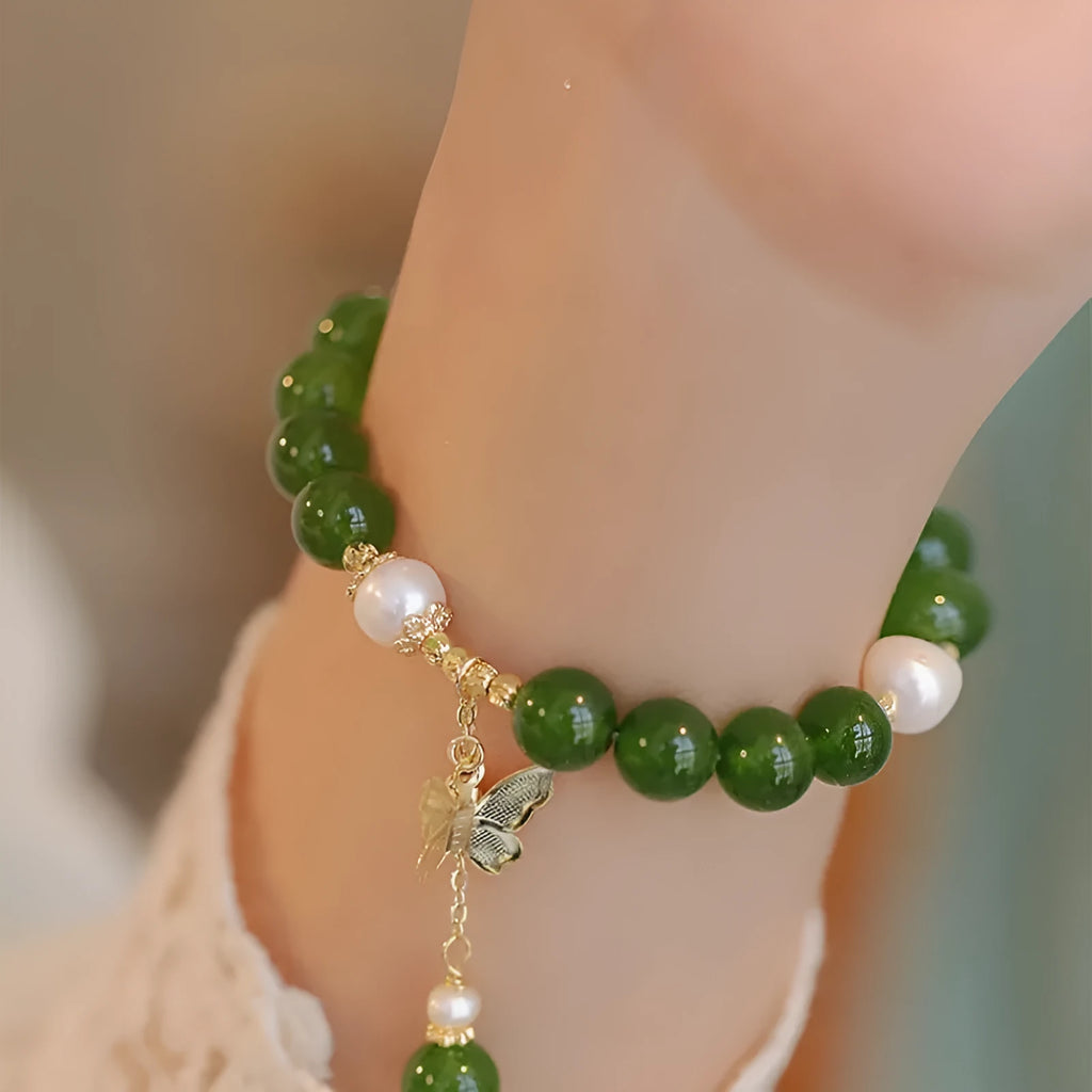 Natural green chalcedony bracelet with round geometric beads on a wrist.