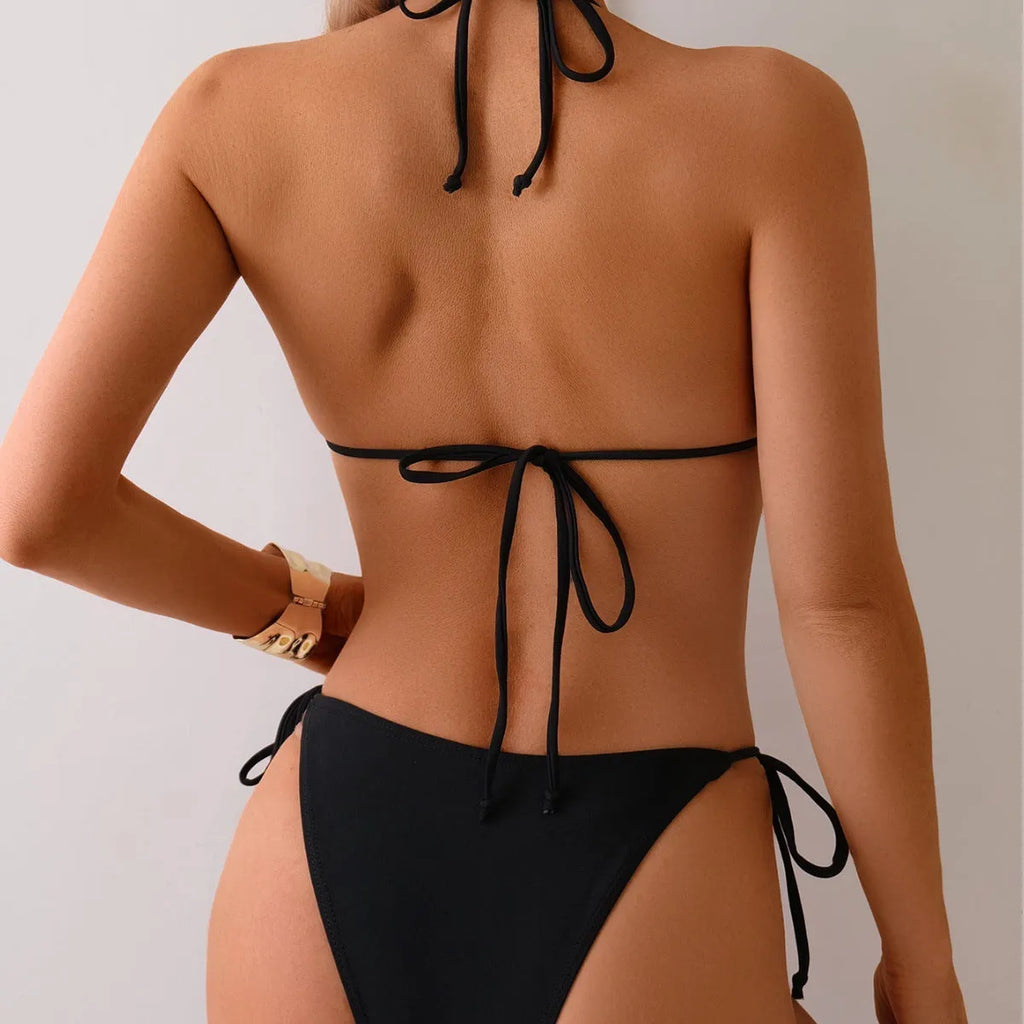 Black women's bikini swimsuit with metal bead detail and split leg design