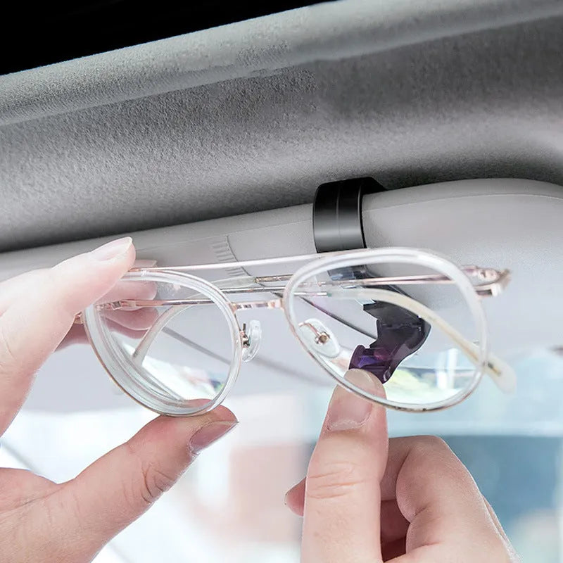Black plastic car sunshade clip for holding glasses and ID cards, shown next to a ruler showing 6.5cm length.