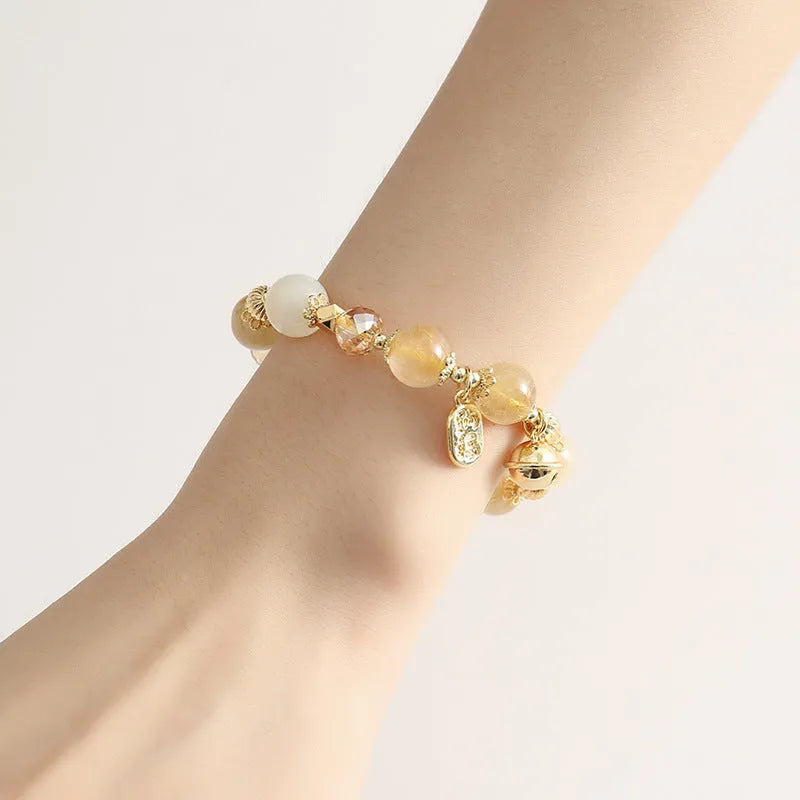 Adjustable gold tone bracelet with rutilated quartz crystal centrepiece and electroplated metal components