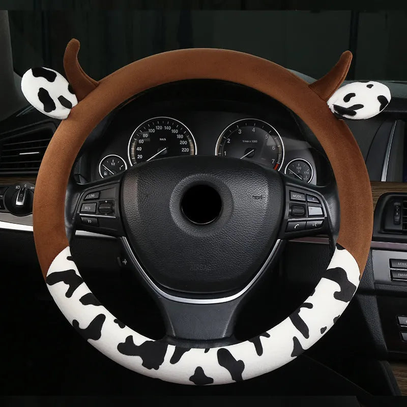 Short plush steering wheel cover with protective handle section in black colour