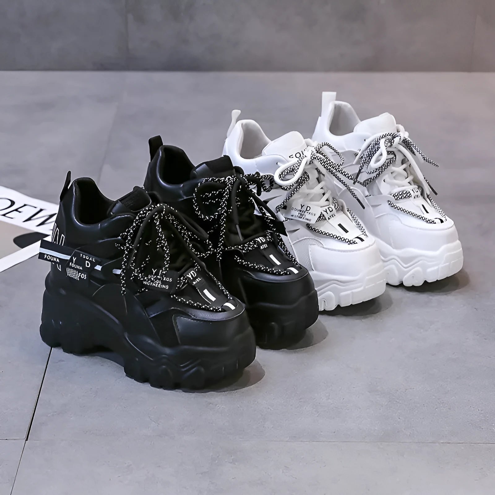 Women's white and black breathable mesh platform sports shoes with cross-strap and rubber sole.