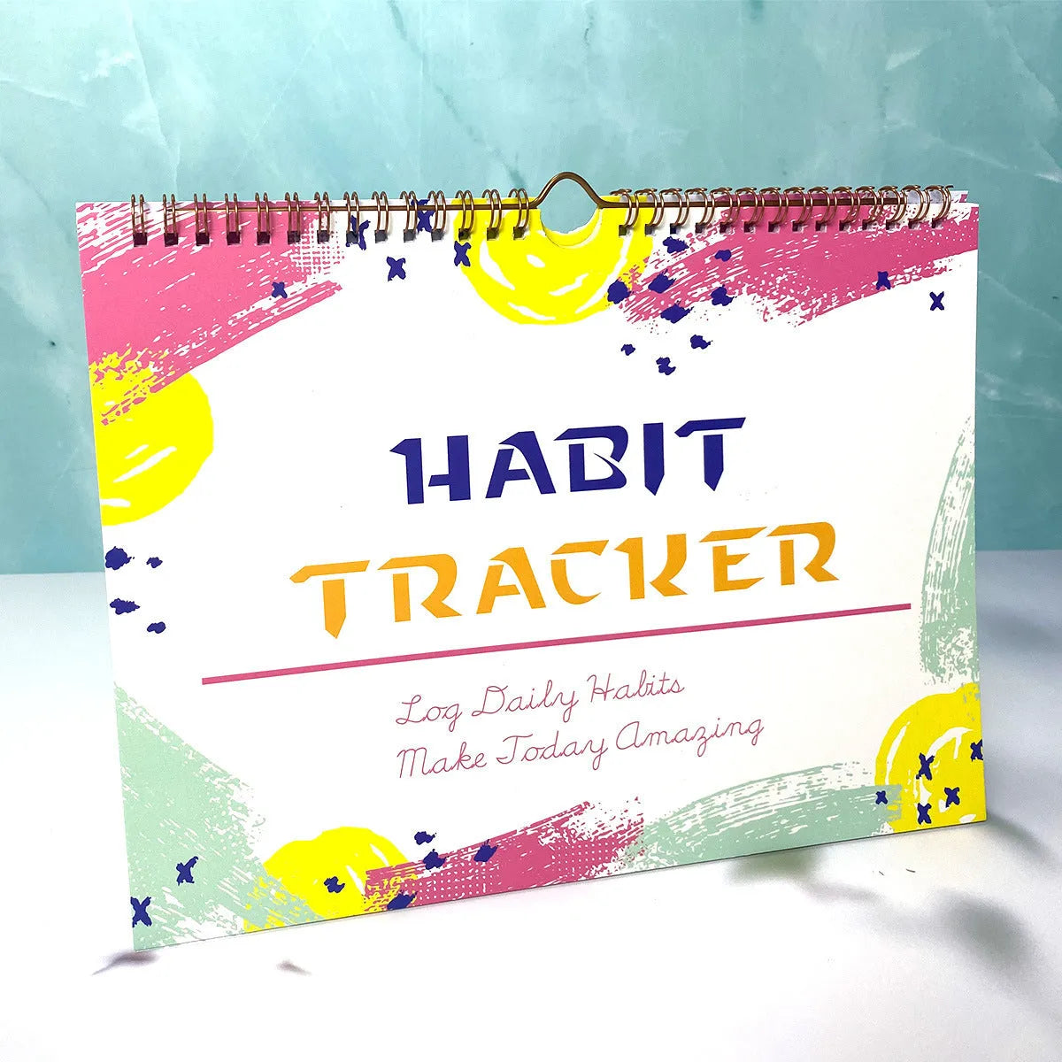 English habit tracking notebook open showing 12 internal pages with A4 21x28cm dimensions