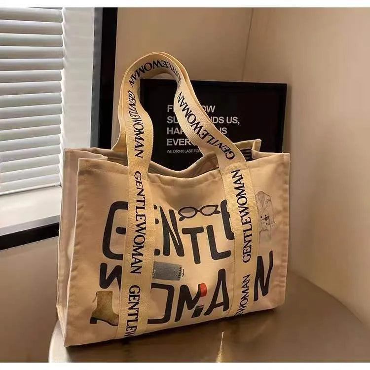 Large canvas women's travel tote bag with shoulder strap and printed design