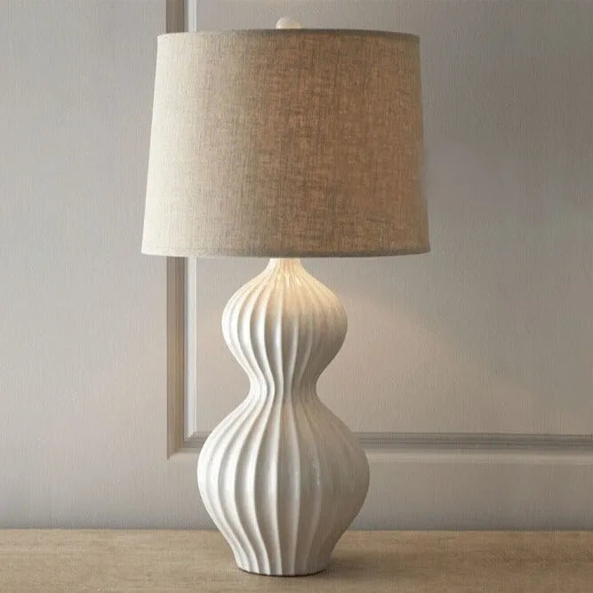 Jingdezhen ceramic table lamp with white fabric shade on wooden table