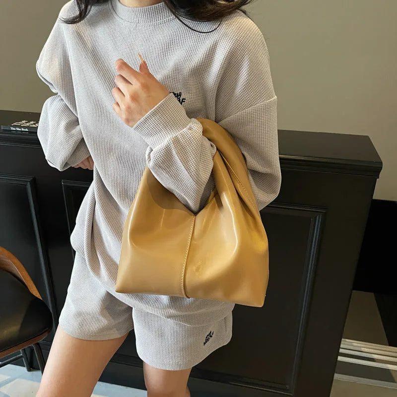Women's casual PU leather foldable dumpling handbag in multiple colours showing sandwich pocket.