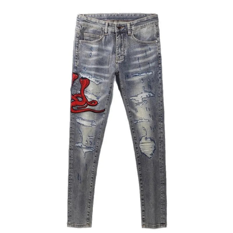 Men's slim fit jeans with embroidered patches and worn wash effect in old colour