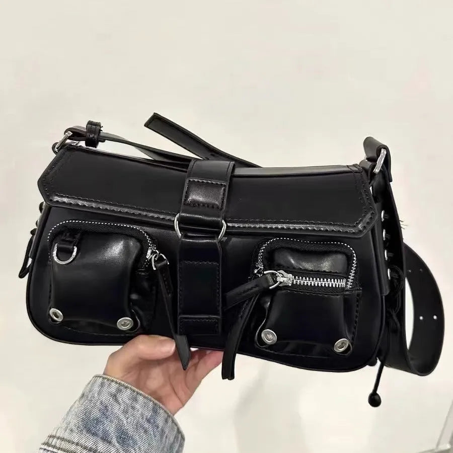 Black women's underarm baguette messenger bag with single shoulder strap showing interior zipper pocket