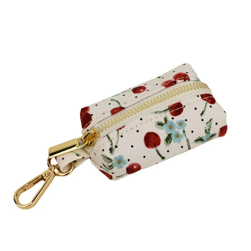 Red cherry print cloth dog collar with light gold release buckle, part of a five-piece pet accessory set.