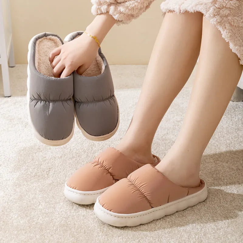 A pair of thick-soled down cotton slippers for men and women in a choice of colours, featuring a non-slip rubber sole.