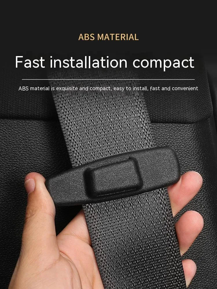 Two black ABS plastic car seatbelt stopper clips for adjusting length and preventing neck pinch.