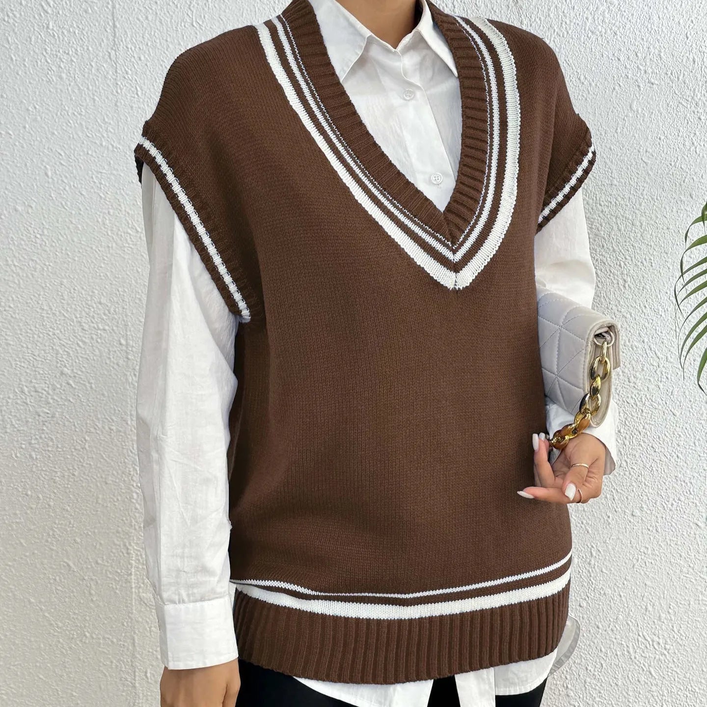 Women's college style wool vest sweater in loose fit pullover design showing black, blue and coffee colour options