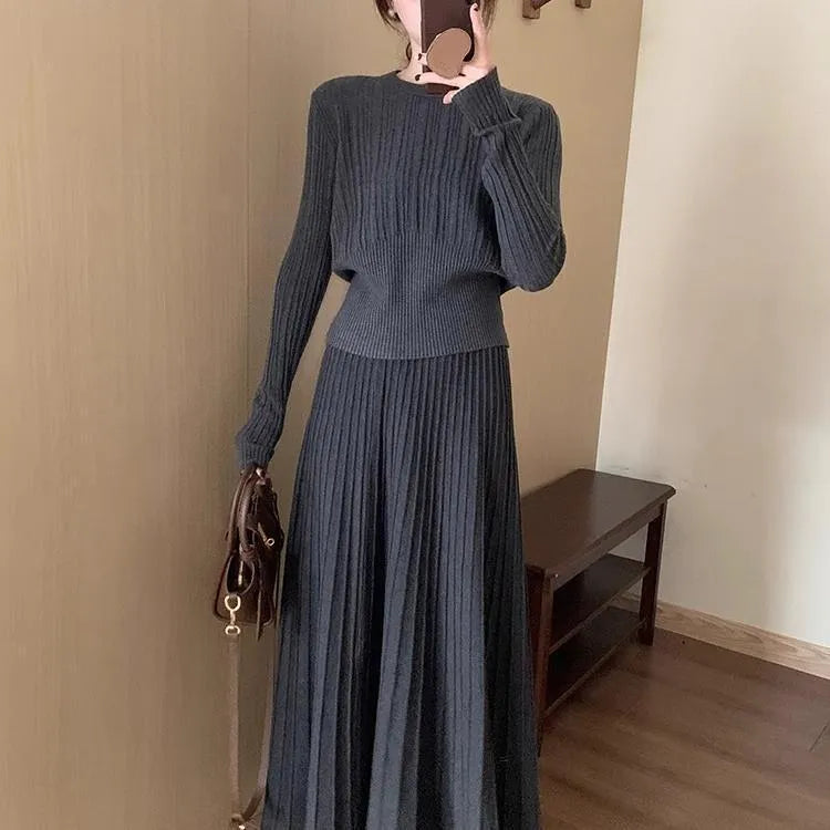 Dark grey knitted two-piece dress suit with 3D pattern, showing sweater and skirt.