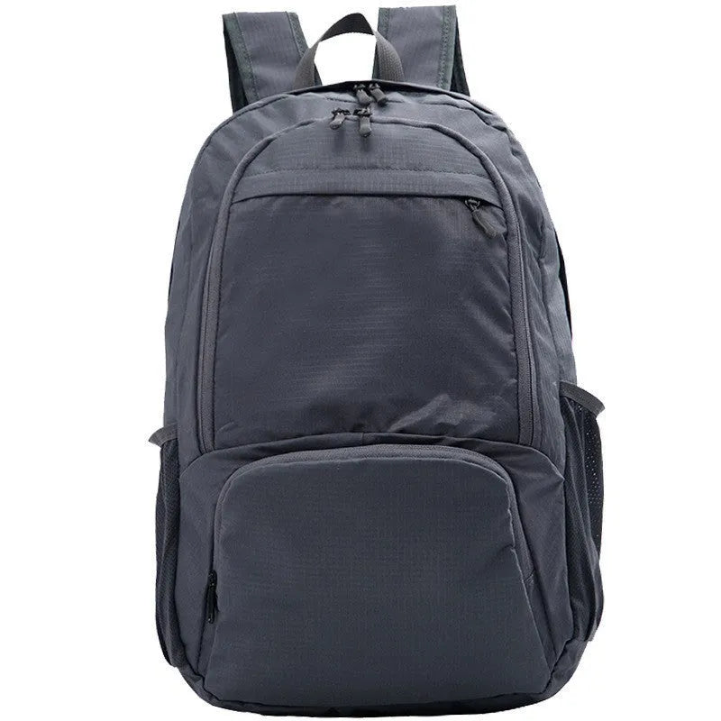 26 inch solid colour foldable backpack in Oxford cloth shown in black, blue, brick red, grey, green, orange, and purple.