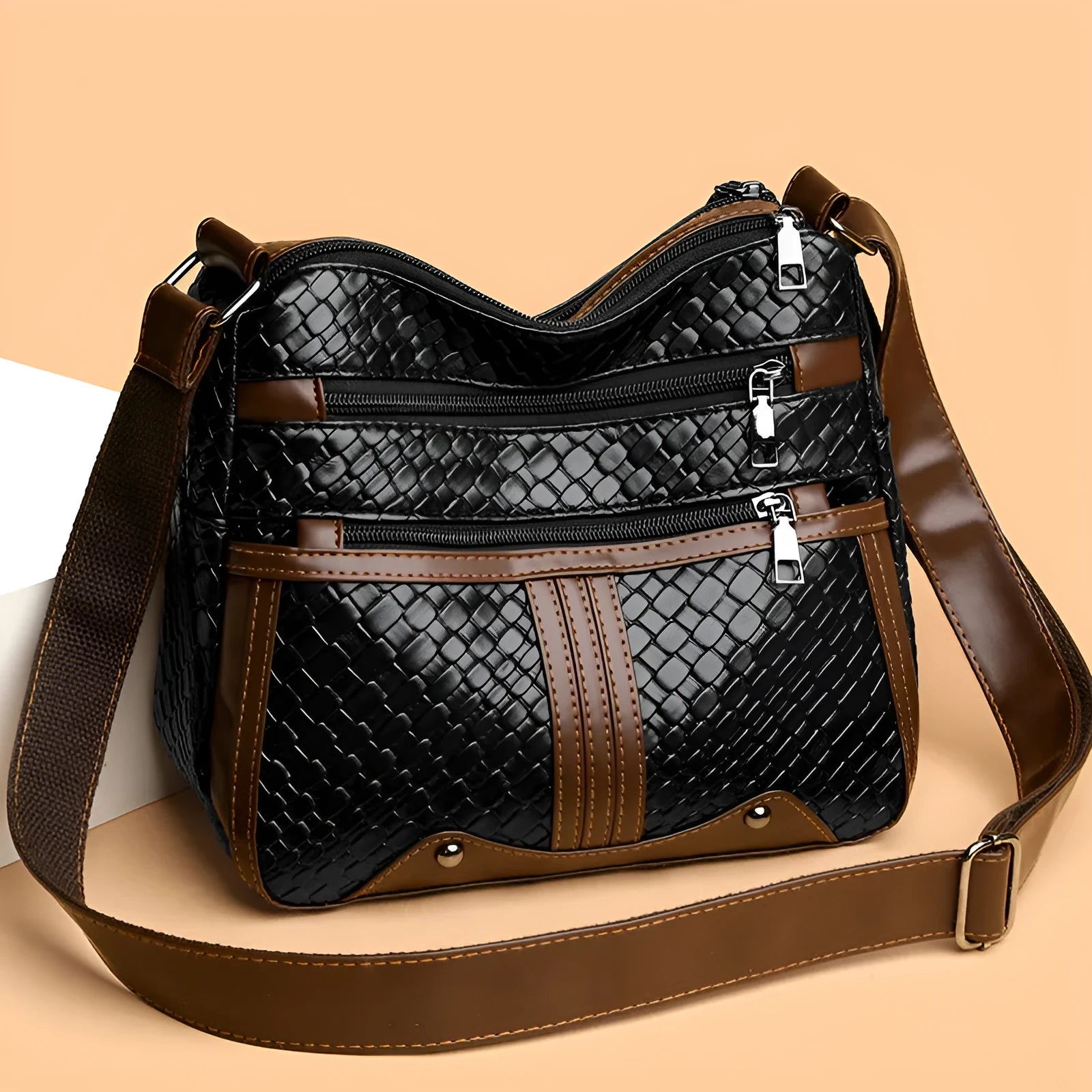 Brown PU leather single shoulder messenger bag with woven strap and multiple compartments.