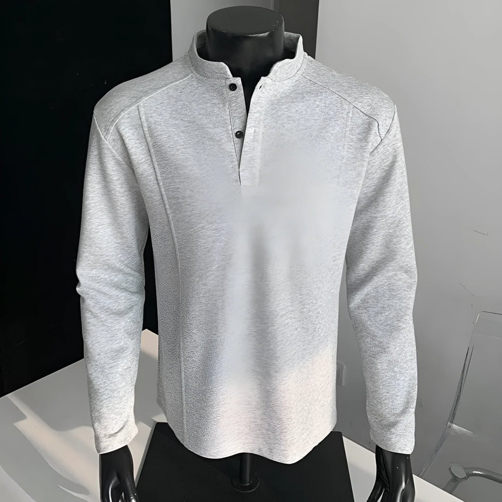 Men's grey asymmetric polo shirt with a patchwork stand-up collar and long sleeves.