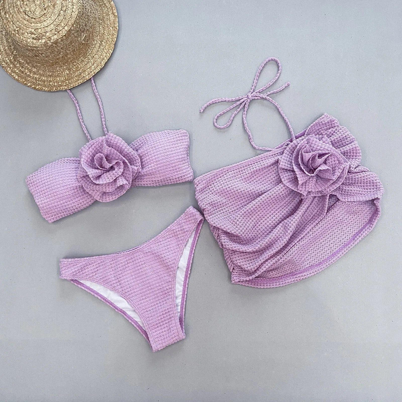 Women's three-piece bikini set with 3D flower split design in purple or white.