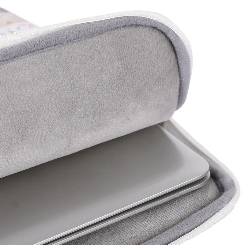White waterproof PU leather laptop inner sleeve for a 14-inch computer on a table.