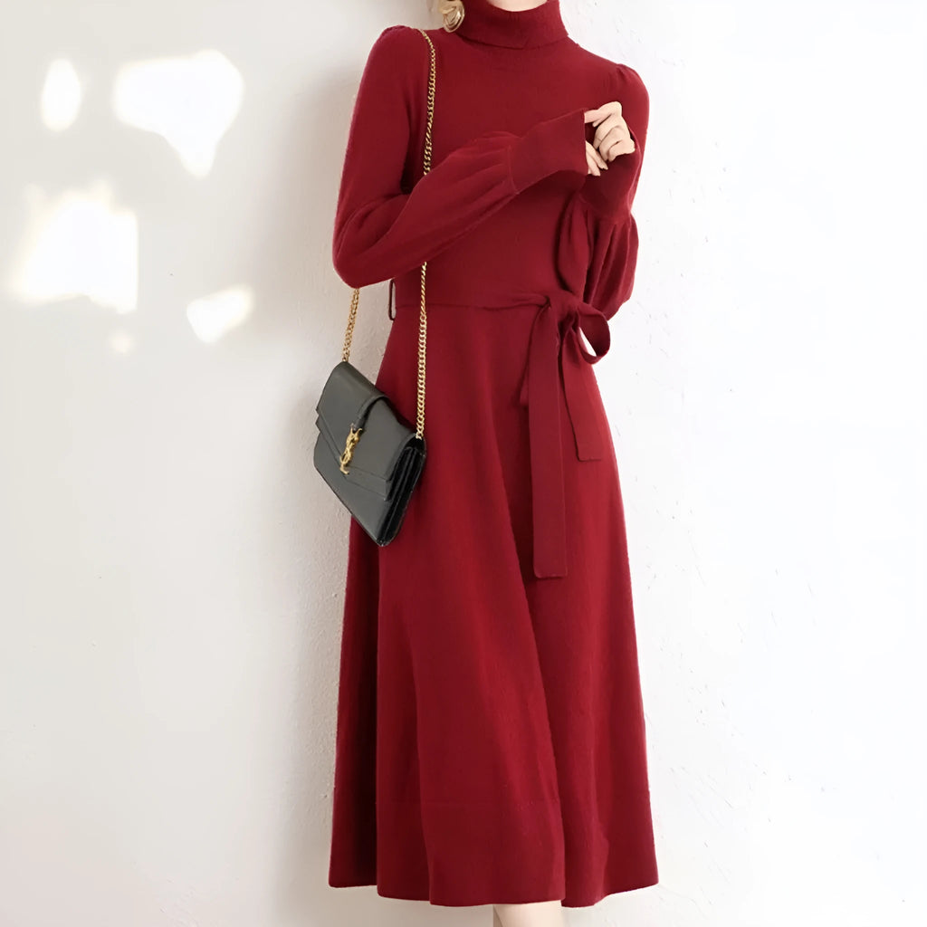 Rose red loose turtleneck knit dress with long sleeves and a flared skirt hem on a hanger.